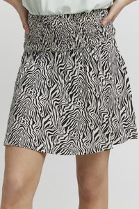Skørt i sort og hvid zebra mønster med elastisk talje. Lavet af letvægtsstof, det har en udvidet form og struktureret mønster.