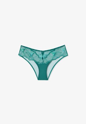 String en maille teal avec détail en dentelle florale à la taille, présentant un tissu semi-transparent et un dos lisse et uni.