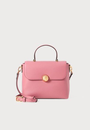 Pink leather handbag with a structured design, a top handle, and a detachable shoulder strap. Features a gold round clasp and textured finish.