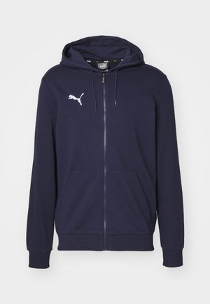 Marineblå zip-up hoodie lavet af blanded bomuldsstof, med en kængurulomme, ribbede manchetter og et hvidt Puma-logo på brystet.