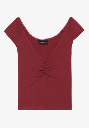 Mauve fitted top with short sleeves, scoop neckline, gathered center detail, and scalloped trim along the neckline and sleeves.