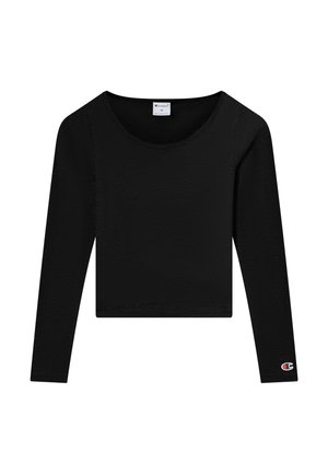 Zwart cropped shirt met lange mouwen en ronde halslijn, Champion-logo op de linkermouwboord, en maatlabel aan de binnenkant van de kraag.