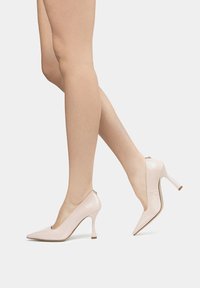 Light pink patent leather high heels with a pointed toe, narrow heel, and an open back design, featuring a sleek and glossy finish.