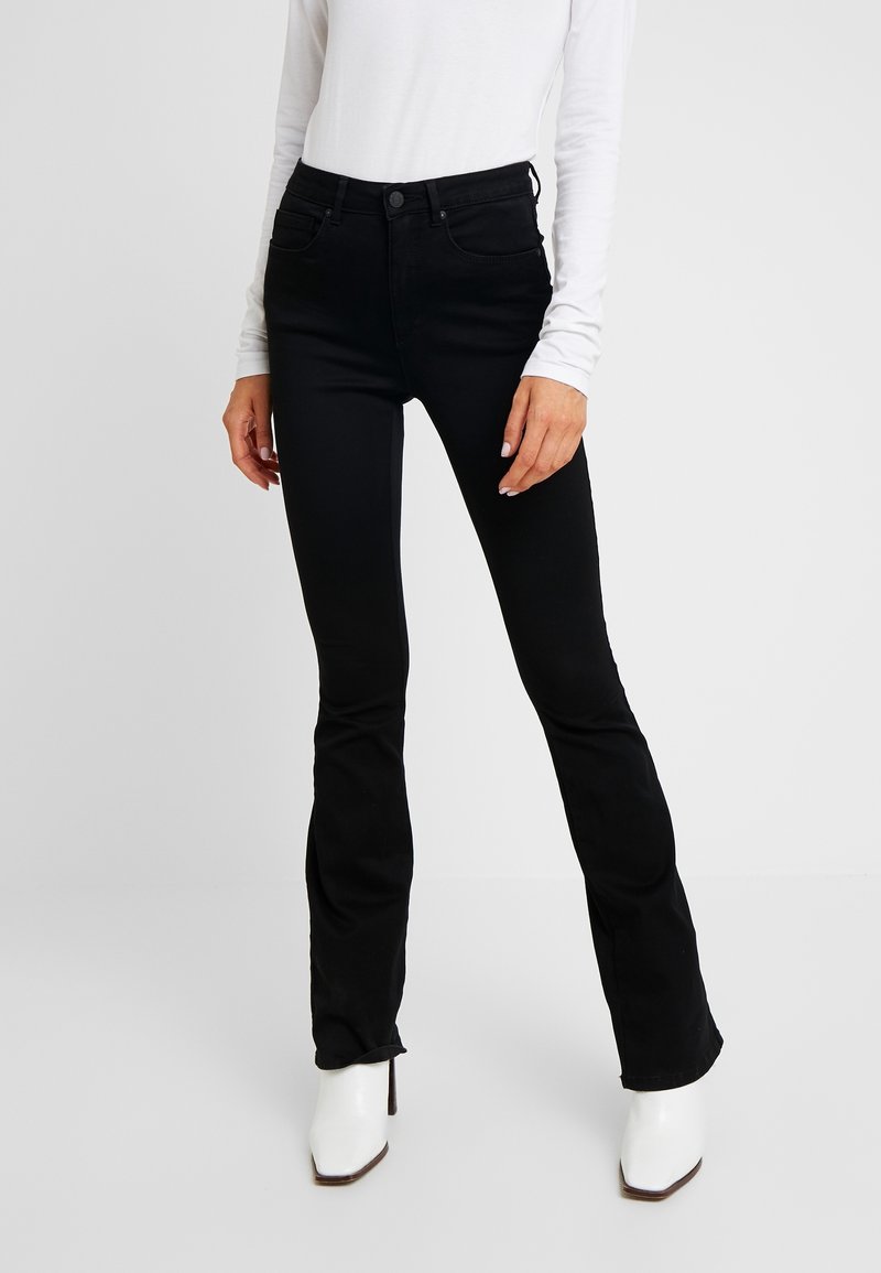 Black flared jeans in a stretch denim fabric, featuring a classic five-pocket design, high waist, and subtle stitching detail.