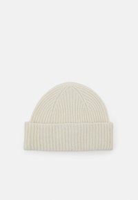 Knit beanie in light beige, featuring ribbed texture and a folded hem. Rounded top with vertical stitching detail.