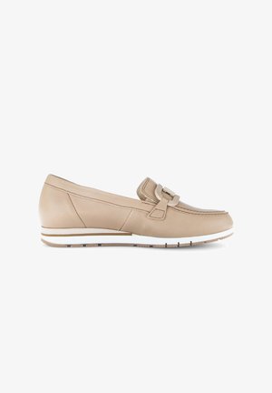 Beige leather loafer with a white and tan rubber sole, decorative strap, and stitching details on a plain white background.