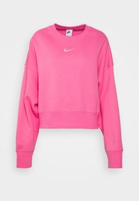 Sweatshirt court rose en tissu doux. Il dispose d'un col rond, de manches tombantes et d'un logo Nike blanc sur la poitrine.