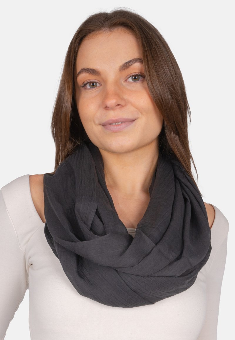 Black infinity scarf made of a textured, lightweight material, draped comfortably around the neck. Simple design without hardware or accents.