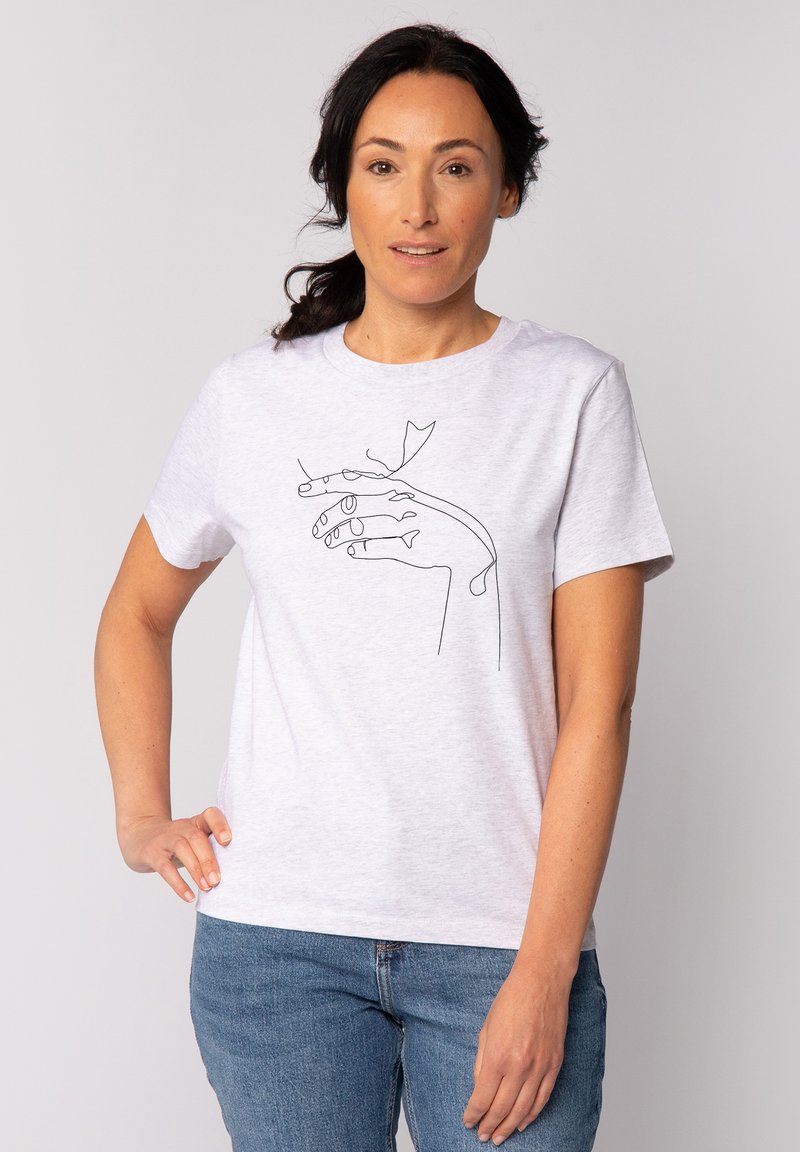 T-shirt gris à manches courtes présentant un dessin en ligne continue d'une main tenant une feuille. Le tissu a une texture douce et lisse.