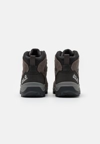 Brown hiking boots with black accents, high-top design, textured fabric, and rubber soles. Features logo detail on heel.