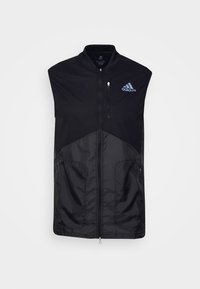 Black sleeveless vest with a zippered front, made of lightweight material. Features a textured lower section and Adidas logo in blue.