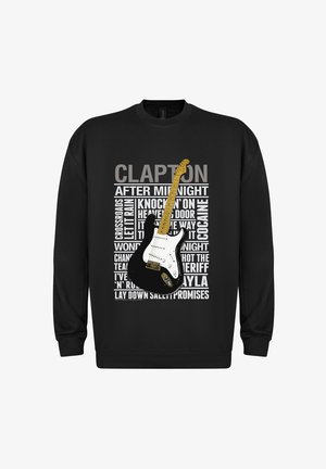 Felpa nera con un grafico di una chitarra affiancato da titoli di canzoni e il nome "CLAPTON" in grassetto, testo bianco e grigio. Tessuto morbido.