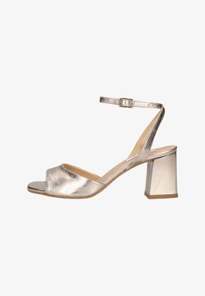Silver metallic open-toe sandal with block heel and ankle strap featuring a small buckle closure.
