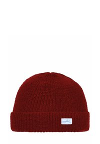 Red knitted beanie hat with a ribbed texture and a folded cuff. Features a small white label on the front, indicating brand name.