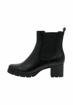 Bottine en cuir noir avec des panneaux élastiques sur les côtés, bout arrondi et talon bloc. Texture lisse avec une languette à l'arrière pour un enfilage facile.