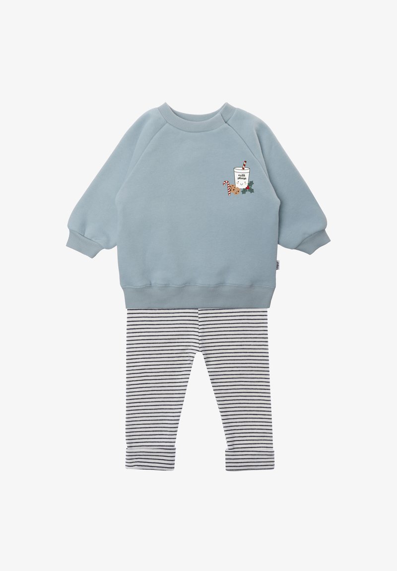 Light blue sweatshirt with a graphic design featuring a drink and candy canes, paired with black and white striped leggings. Soft material.