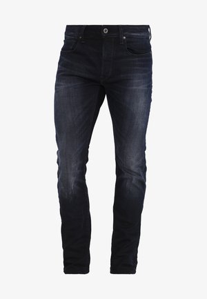 Donkerblauwe denim jeans met een slim fit, voorzien van subtiele wassing, een klassiek 5-pocket ontwerp en een ritsvlieg met een knoopsluiting.