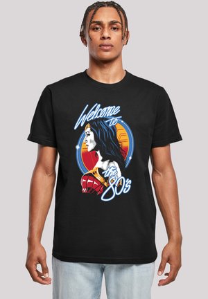 Black t-shirt featuring a colorful graphic illustration of a female character and the text "Welcome to the 80s" in retro style.