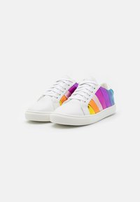 Białe sneakersy z wielokolorowymi paskami w kolorach purpurowym, różowym, pomarańczowym i niebieskim. Posiadają teksturowaną cholewkę i płaską gumową podeszwę.