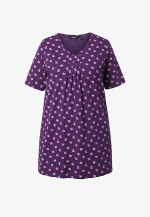 Tunique violette à manches courtes et col en V, avec un motif de petits pois floraux roses et blancs, et des plis au centre devant.