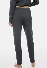 Donkergrijze, stretchbroek met een gladde textuur, slim fit en elastische tailleband, met een recht pijpdesign en geen zichtbare patronen.