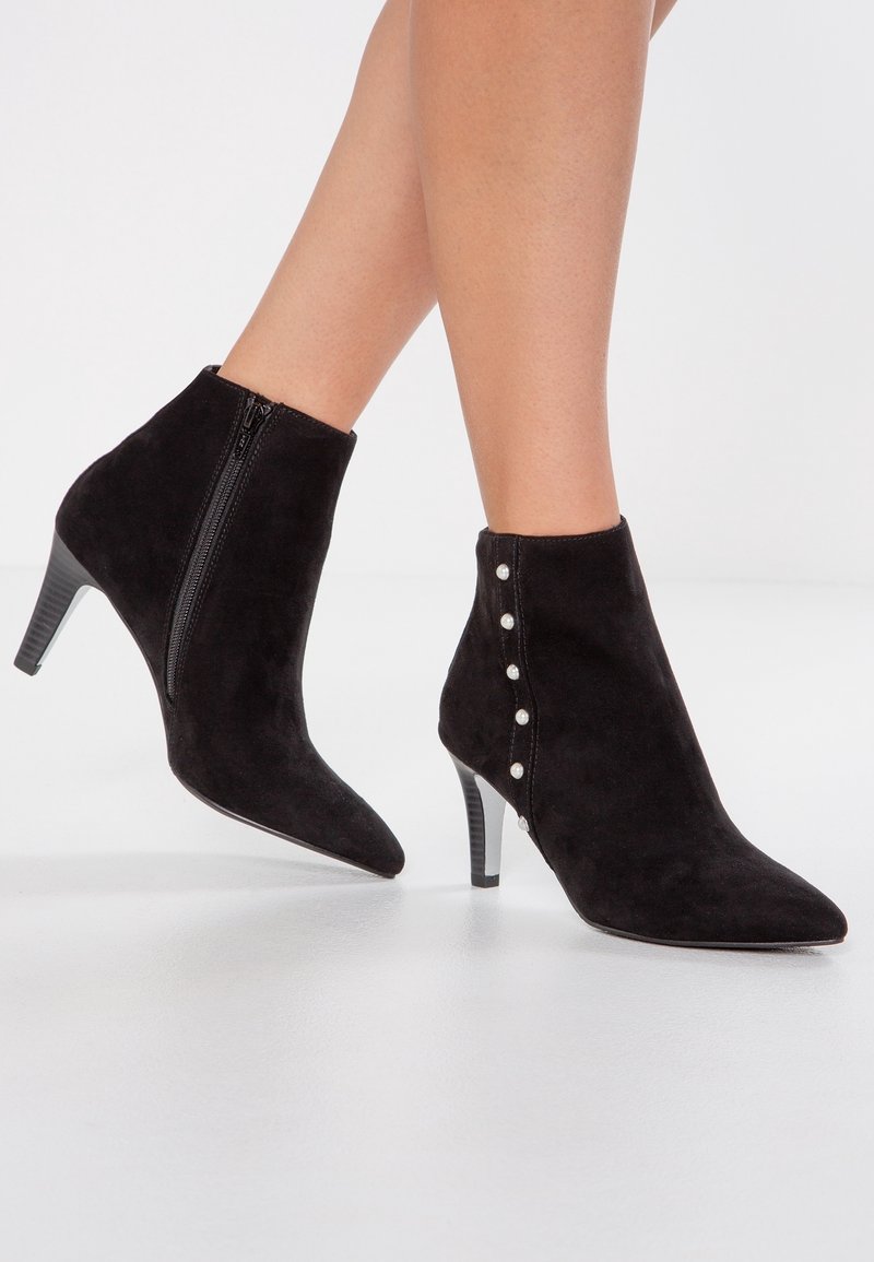 Black suede ankle boots with a pointed toe, side zipper, and decorative pearl accents along the outer side. Stiletto heel design.