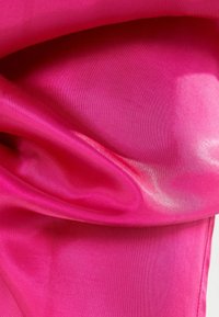 Bright pink satin fabric with smooth texture, showing subtle sheen and draped folds, highlighting its rich color and luxurious appearance.