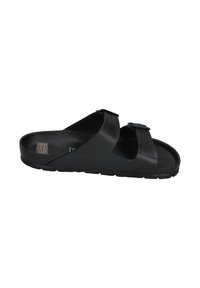 Black slide sandal with two adjustable straps, made of smooth leather, featuring a textured sole and minimalistic design.