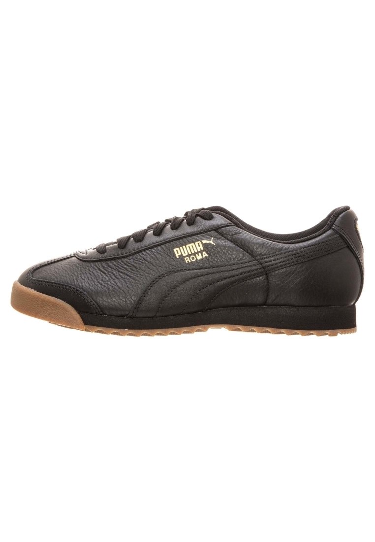Svart Puma Roma lädersneaker med gummisula, snörning och guld Puma-logotyp på sidan.