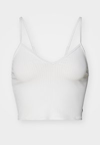 Biały prążkowany crop top z regulowanymi ramiączkami spaghetti i dekoltem w kształcie litery V. Posiada gładką teksturę oraz dopasowany krój.