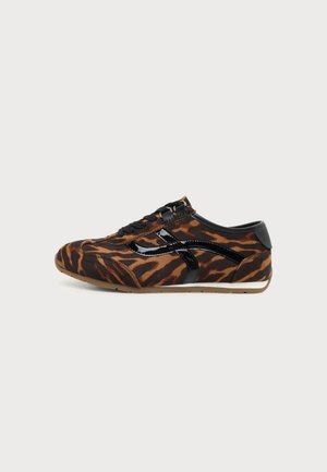 Baskets profil bas avec imprimé tigre marron et noir, détails en cuir verni noir, lacets noirs et semelle en caoutchouc brun clair.