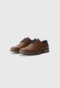 Chaussures en cuir marron avec une texture lisse, présentent des coutures contrastées, un bout rond et un petit talon empilé. Comprend une doublure bleue et un système de laçage.