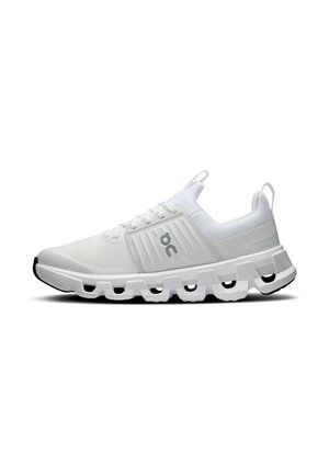 White athletic shoes with a mesh upper, a distinctive midsole featuring hollowed-out sections, and a textured black sole.