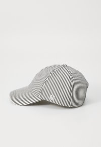 Black and white striped baseball cap with curved brim, fabric texture and embroidered logo on the side. Classic six-panel design.