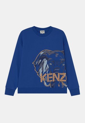Niebieska bluza z nadrukiem słonia w odcieniach niebieskiego i złotego oraz napisem "KENZO" wytłuszczonym, złotym fontem. Miękka w dotyku i o luźnym kroju.