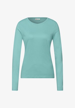 Yksinkertainen vaaleansininen pitkähihainen naisten paita pyöreällä pääntiellä, vartalonmyötäinen leikkaus ja sileä kangaspinta, valkoisella taustalla esitetty.