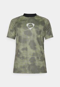 Camisa atlética de manga corta hecha de tela transpirable, con un patrón de puntos negro y amarillo neón y un logo blanco en el pecho.