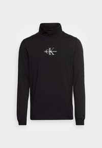 Schwarzes Langarm-Turtleneck-Shirt mit weißem Calvin Klein Jeans-Logo, das auf der Brust zentriert ist, und kleinem Logo am linken Ärmelbündchen.