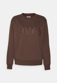 Brun sweatshirt med ribbade muddar och fåll, med "LONDON" i kontrasterande broderade bokstäver över bröstet. Ledig passform.