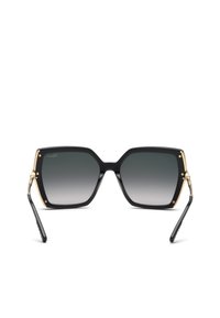 Lunettes de soleil carrées noires surdimensionnées avec verres gris dégradés et détail chaîne dorée sur les branches, vues de face.