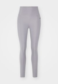 Leggings sportivi grigi realizzati in tessuto elasticizzato, dotati di una vita alta e di un design aderente. Presentano un marchio discreto sulla coscia.