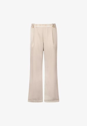 Pantaloni ampi beige con una trama liscia, dotati di una vita elastica con logo e dettagli decorativi in oro sui lati.