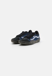 Black and navy blue sneakers with a textured suede toe, mesh and fabric upper, rubber sole, and white striped accents on the side.