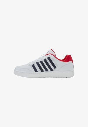 White athletic shoe with a smooth leather upper, navy stripes, red heel, and white rubber sole. Features lace-up design and perforated details.