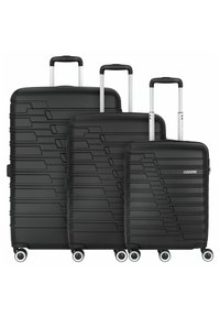 Three black hardshell suitcases in graduated sizes with textured linear patterns, silver retractable handles, and four wheels each.