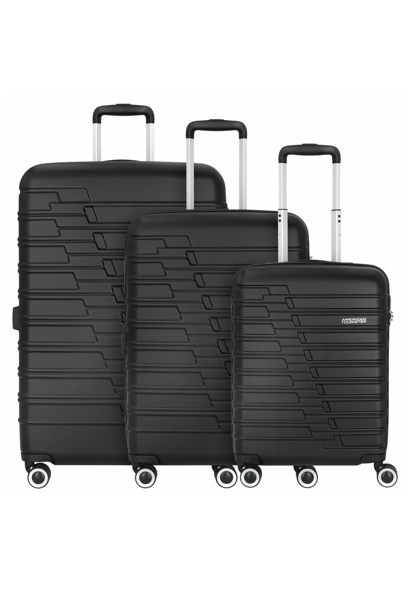 Three black hardshell suitcases in graduated sizes with textured linear patterns, silver retractable handles, and four wheels each.