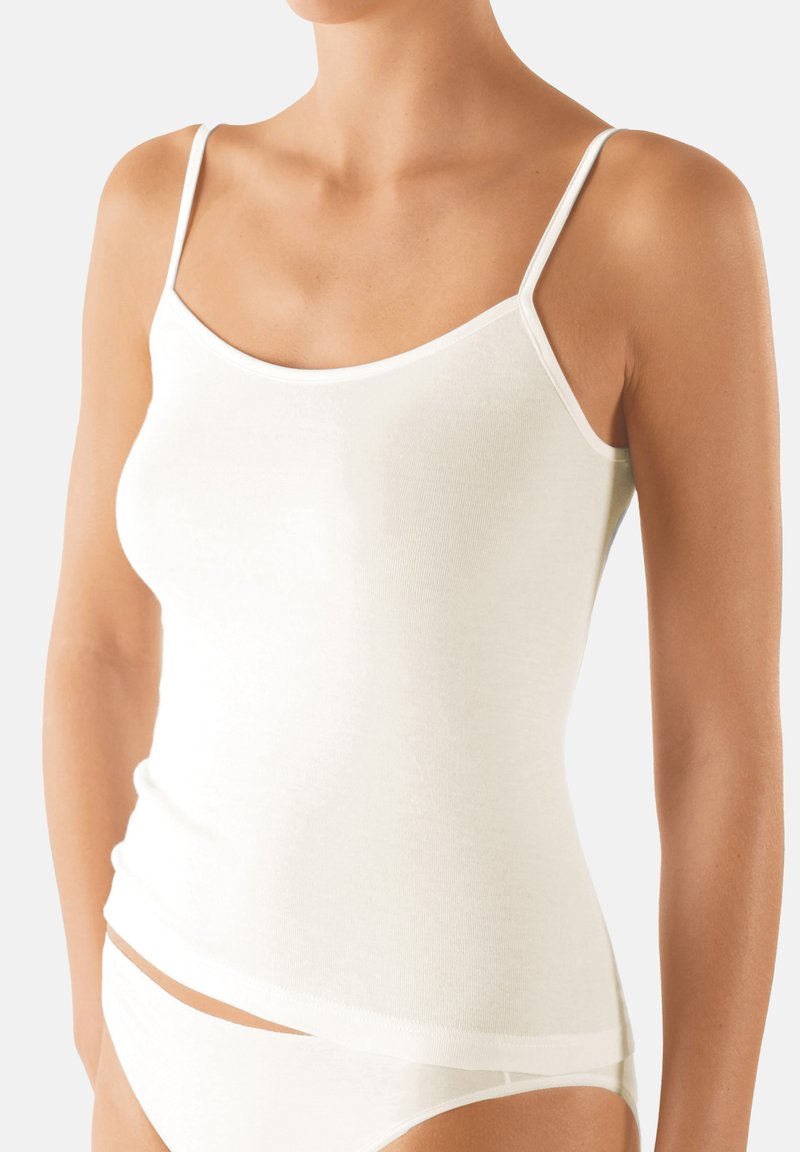 White, sleeveless camisole with thin straps, made of soft cotton blend fabric. Features a fitted silhouette and a smooth texture.