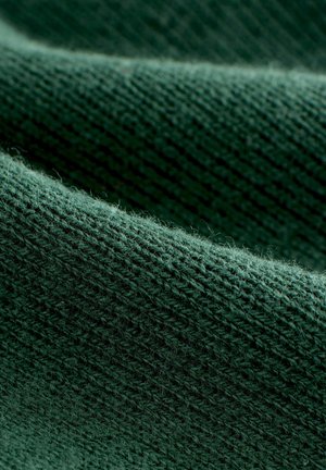 Dark green knitted fabric with a soft, textured surface. Visible stitch patterns and light fuzziness enhance the overall appearance.