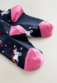 Navy socks with pink toe and heel accents featuring unicorn and colorful dot patterns. Made of soft fabric, suitable for casual wear.
