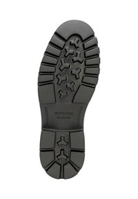 Schwarze Gummisohle mit tiefem Profil. Prägiertes "WITTCHEN handmade"-Logo nahe der Ferse. Verfügt über kantige Rillen für zusätzlichen Halt.